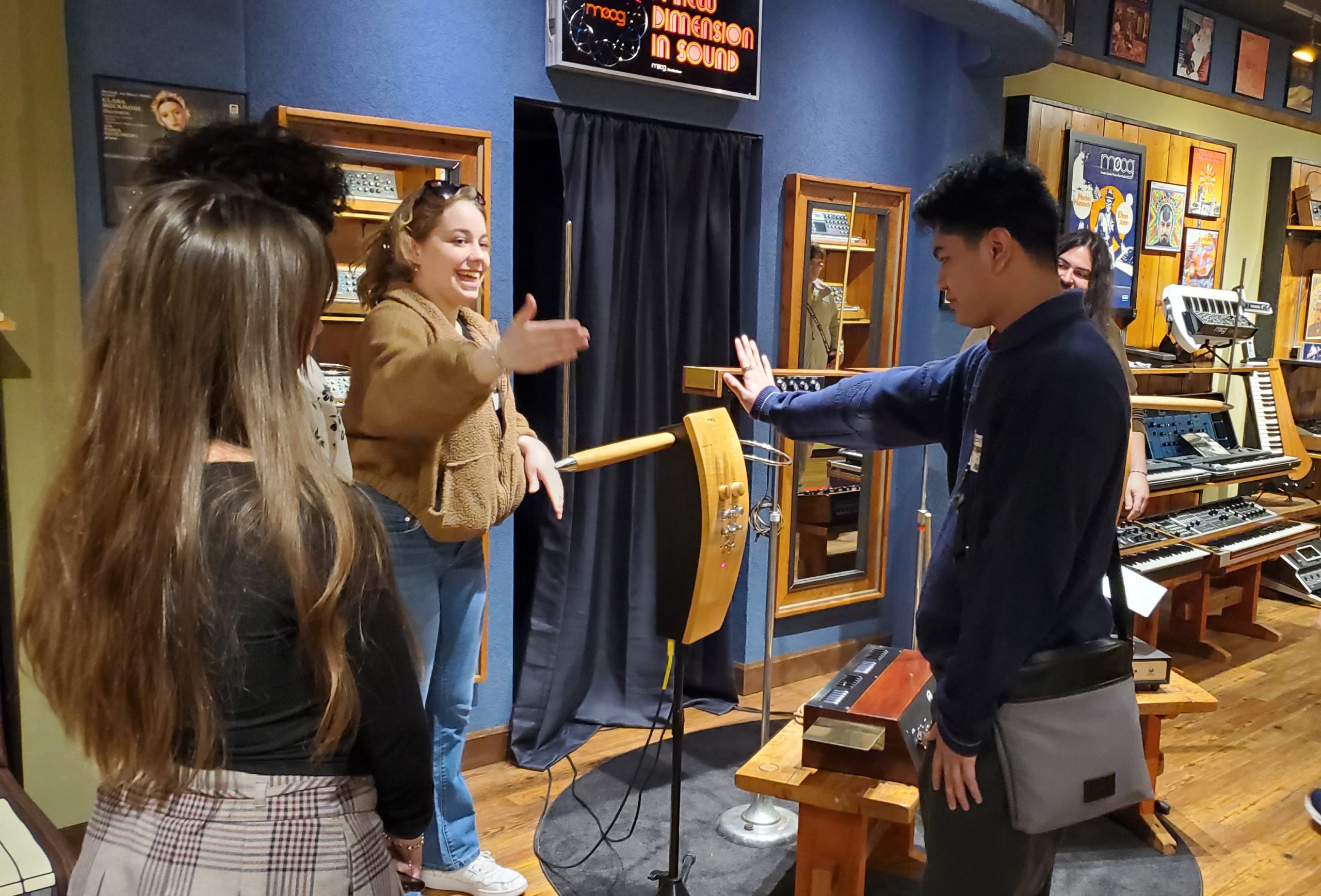 Students playing a theremin